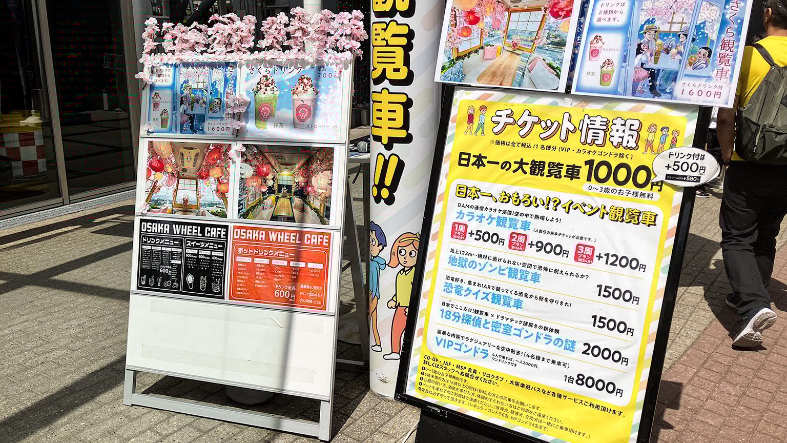 OSAKA WHEEL のチケット情報とカフェメニューの案内の看板の写真